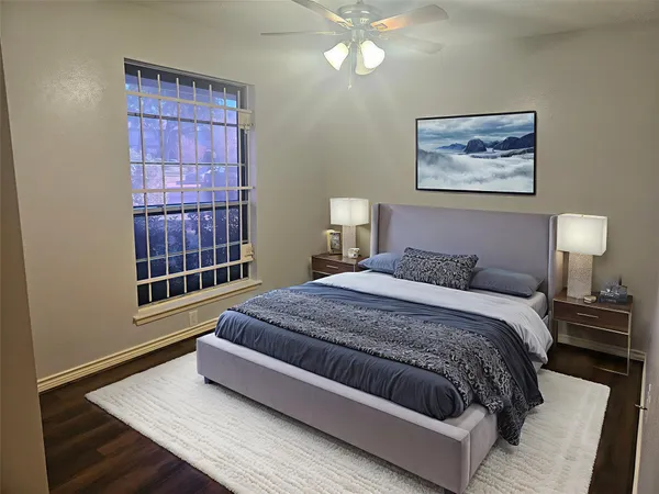 a brick house with a big yard and large trees