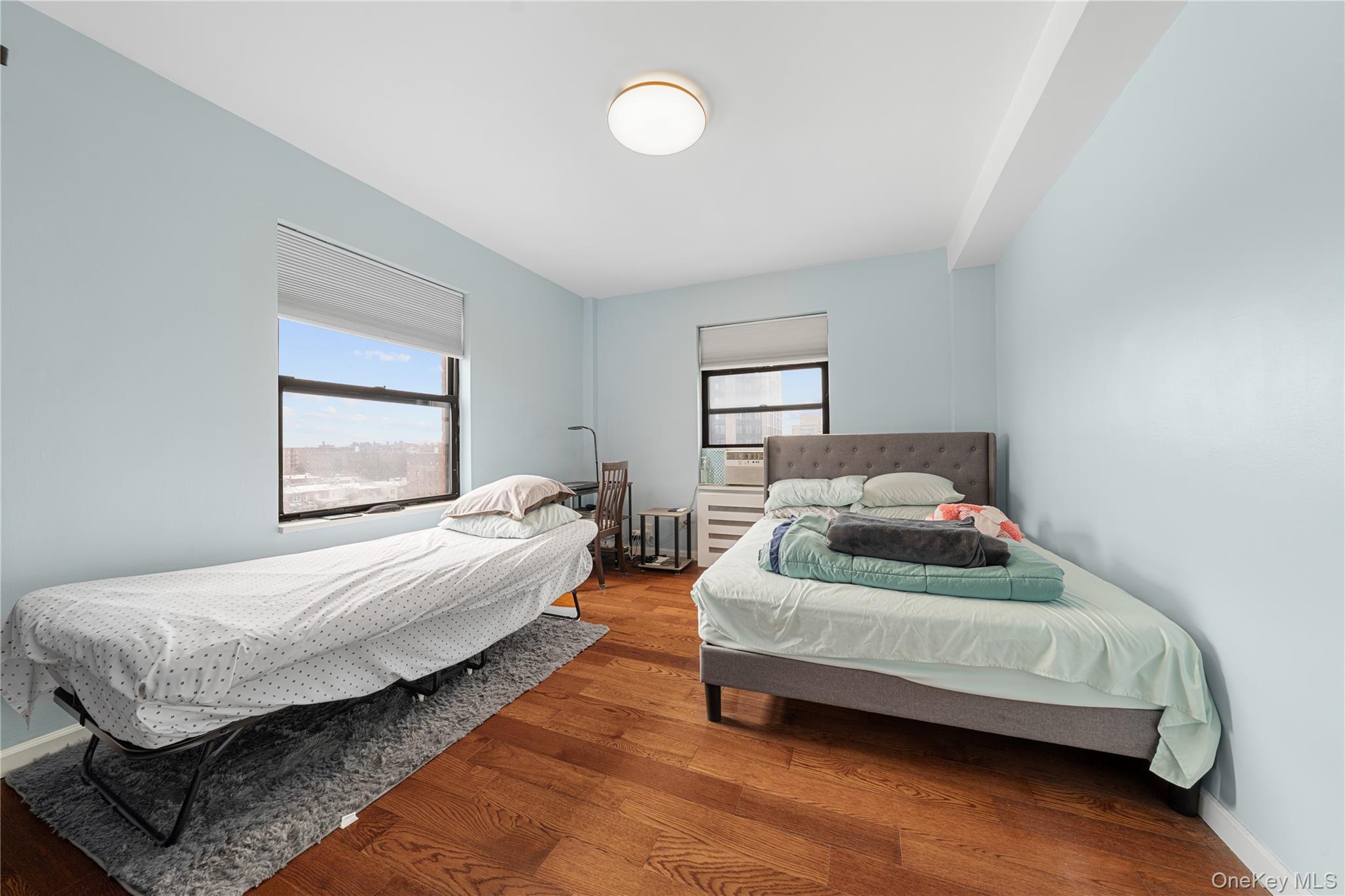 99-32 66th Road, Unit 5K Queens, NY 11374 - Photo 14 of 20 Bedroom with multiple windows and hardwood / wood-style floors