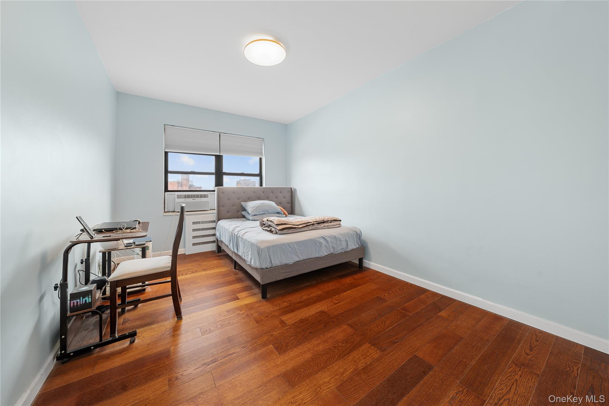 99-32 66th Road, Unit 5K Queens, NY 11374 - Photo 15 of 20 Bedroom with baseboards and hardwood / wood-style floors