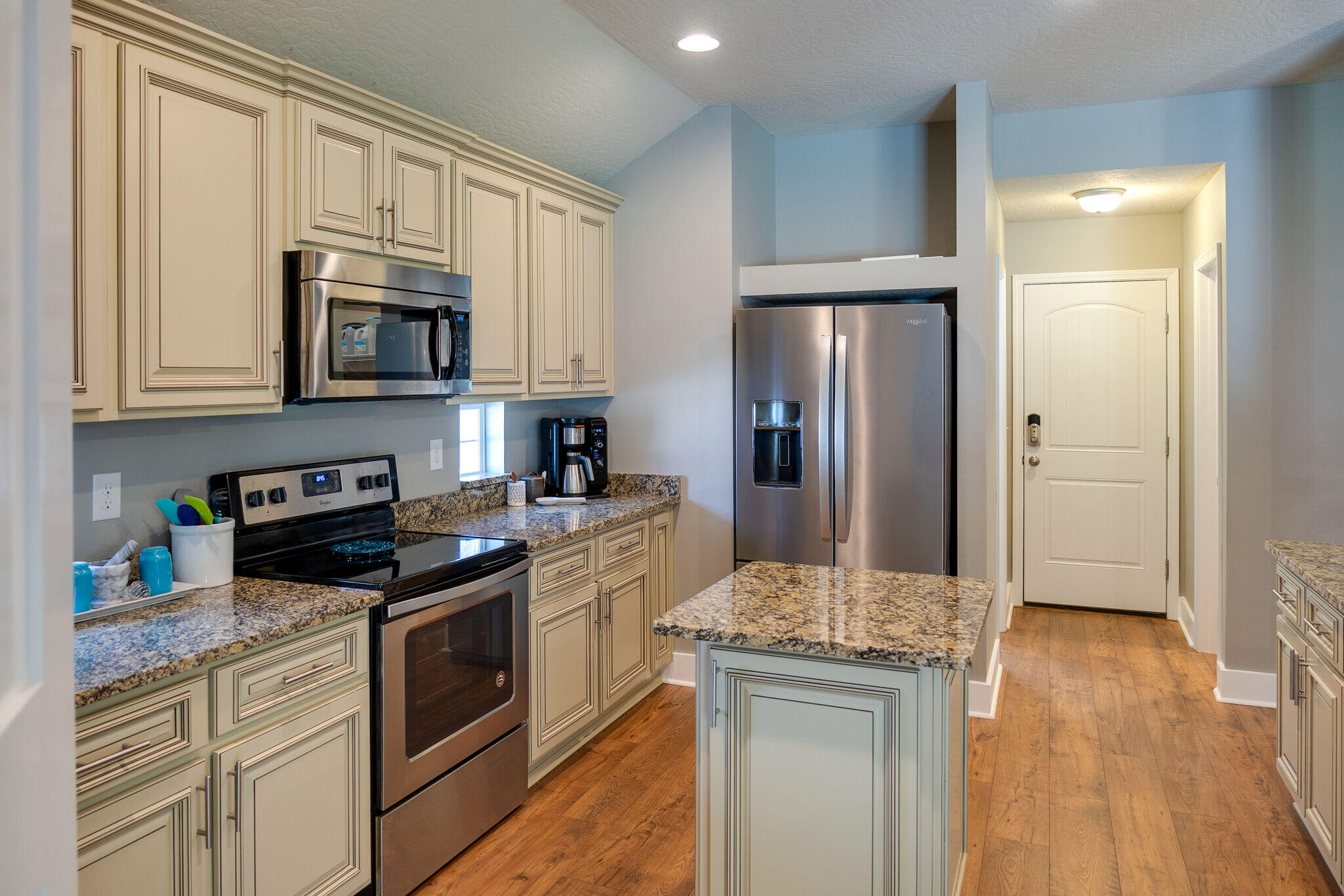 4723 Chanson Crossing Crestview, FL 32539 - Photo 17 of 58 a kitchen with stainless steel appliances granite countertop a refrigerator stove microwave and sink