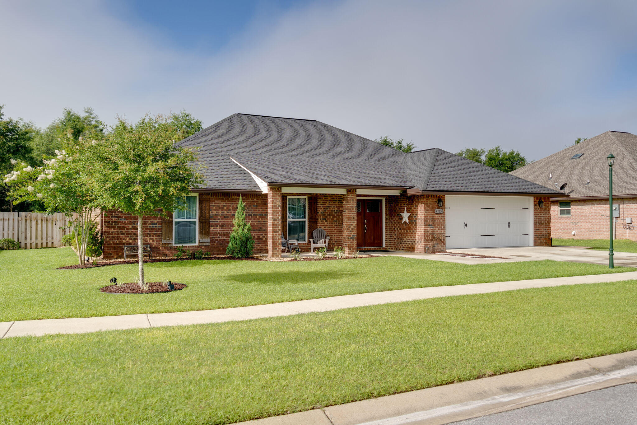 4723 Chanson Crossing Crestview, FL 32539 - Photo 2 of 58 a front view of a house with a yard and trees