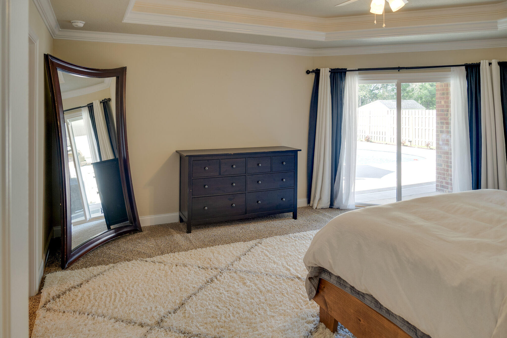 4723 Chanson Crossing Crestview, FL 32539 - Photo 25 of 58 a bedroom with a bed and a dresser next to a window