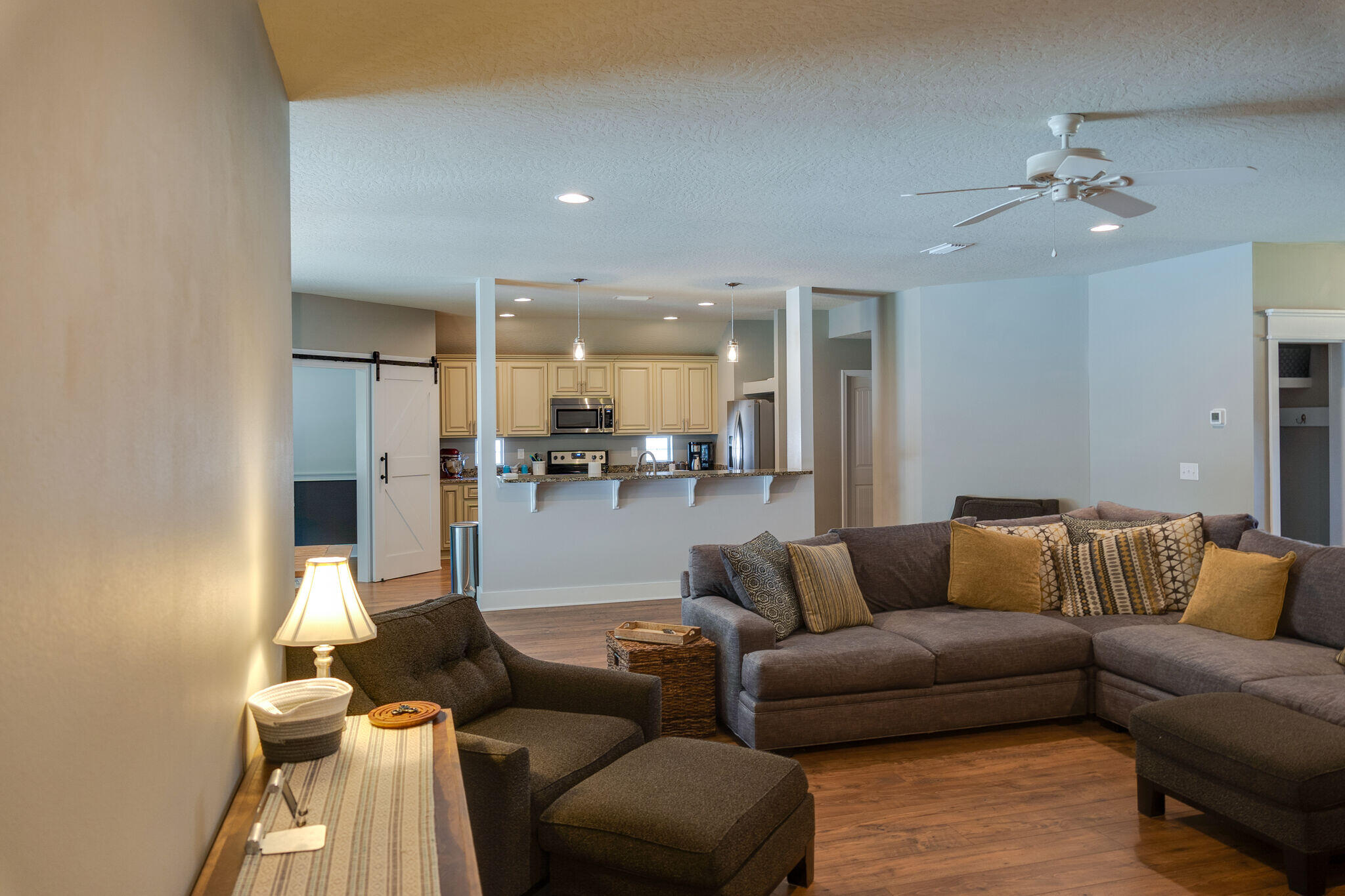 4723 Chanson Crossing Crestview, FL 32539 - Photo 32 of 58 a living room with furniture and kitchen view
