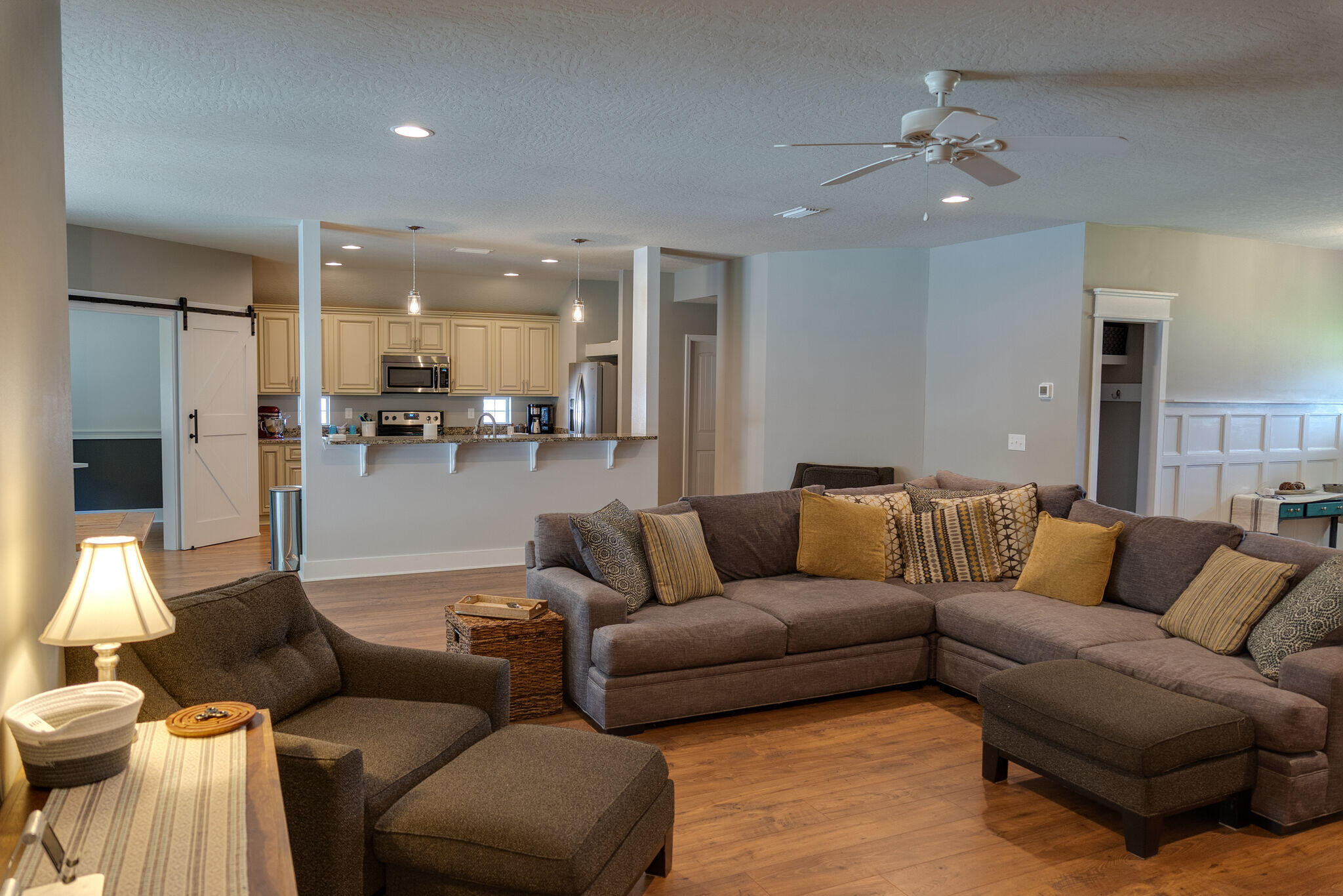 4723 Chanson Crossing Crestview, FL 32539 - Photo 33 of 58 a living room with furniture and kitchen view