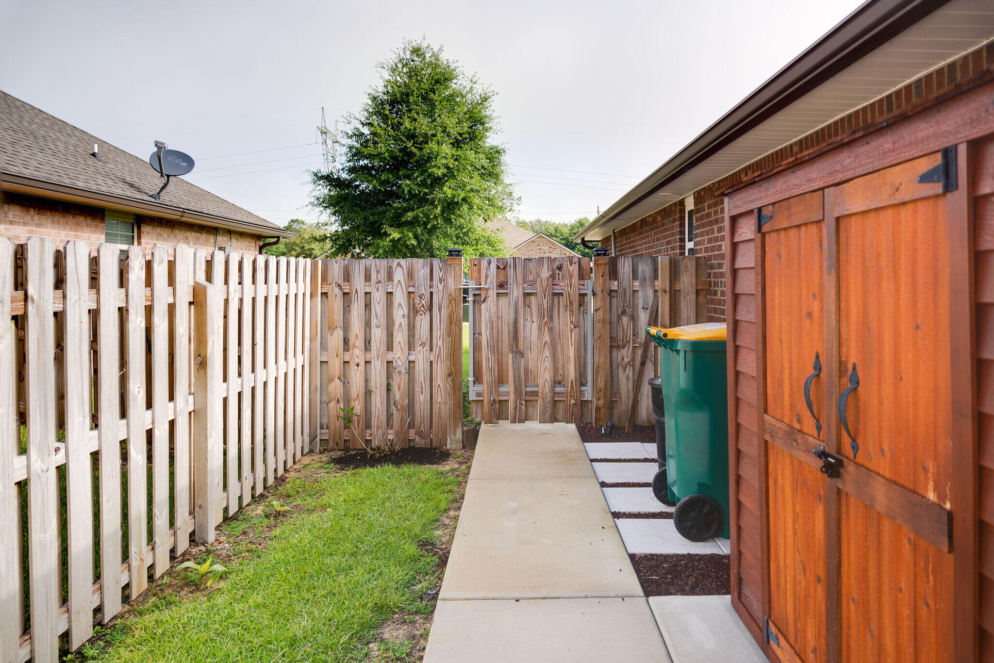 4723 Chanson Crossing Crestview, FL 32539 - Photo 44 of 58 a view of a pathway with a wooden fence