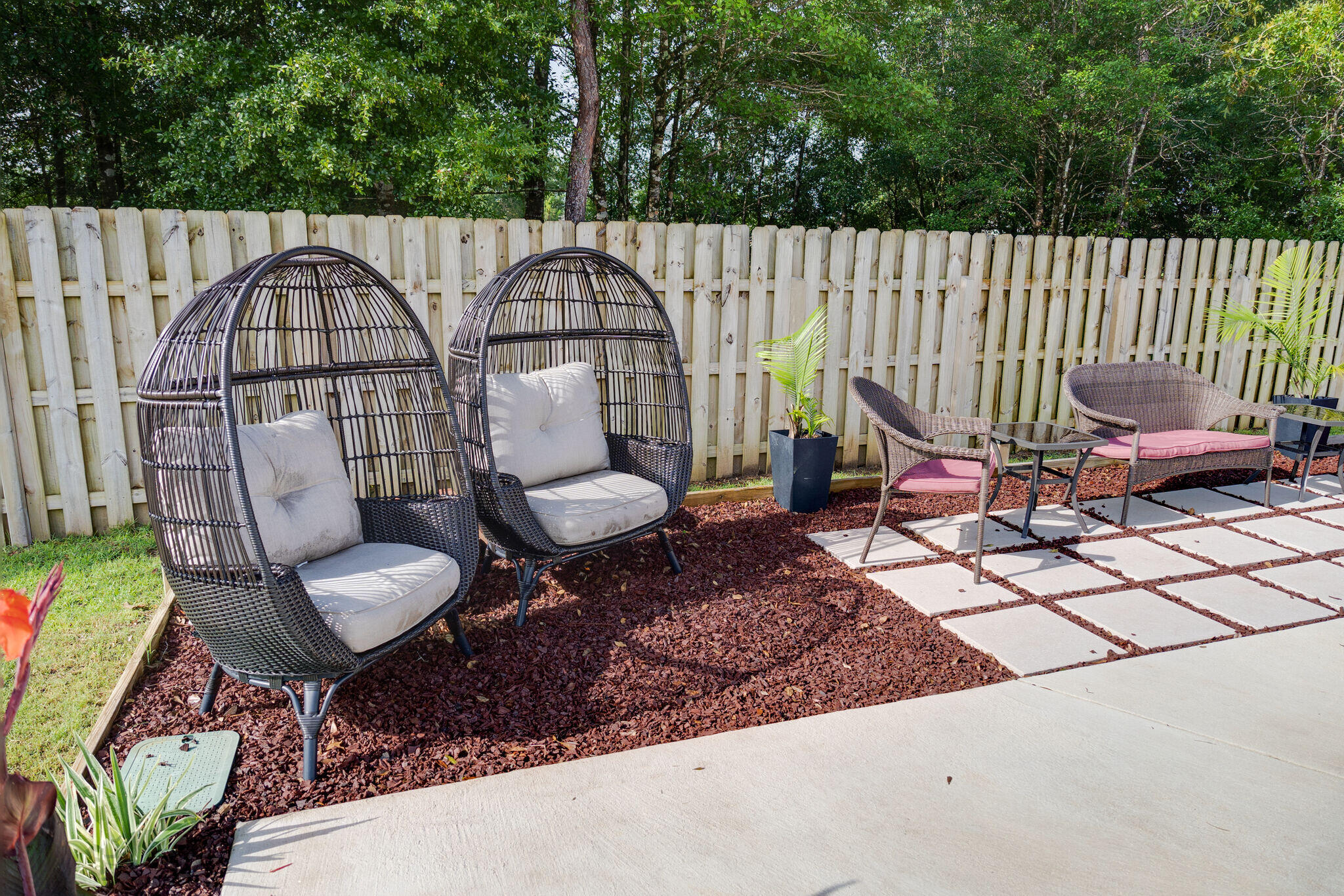 4723 Chanson Crossing Crestview, FL 32539 - Photo 50 of 58 a view of a chair and table in backyard