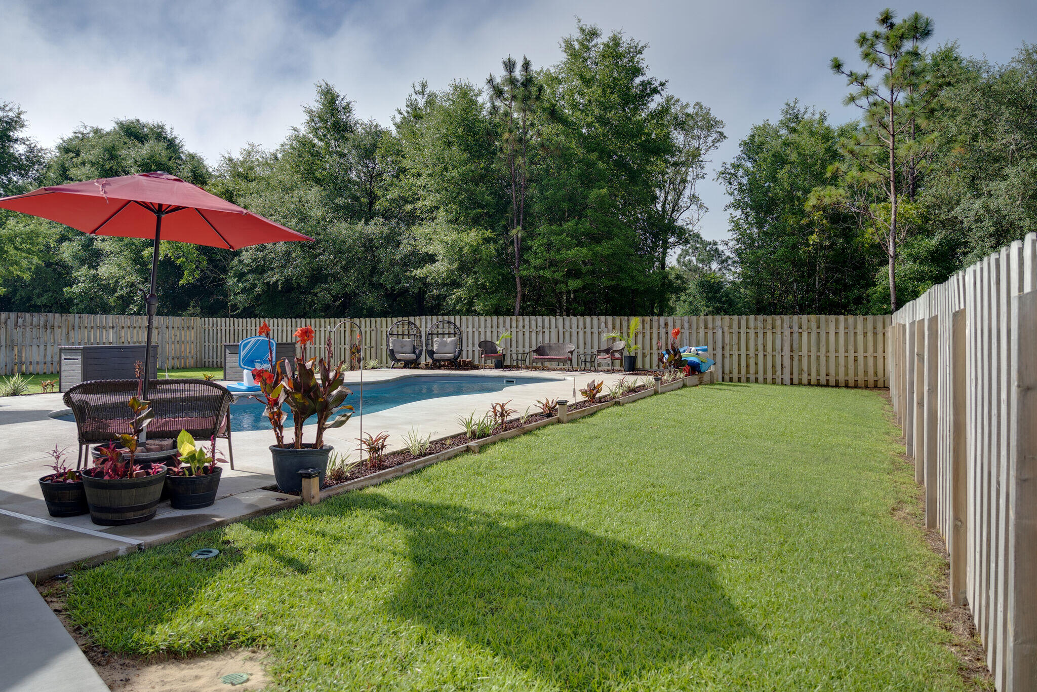 4723 Chanson Crossing Crestview, FL 32539 - Photo 54 of 58 an outdoor space with furniture and umbrella