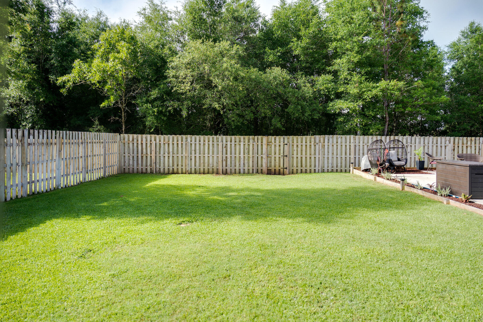 4723 Chanson Crossing Crestview, FL 32539 - Photo 58 of 58 a view of backyard with a garden and deck