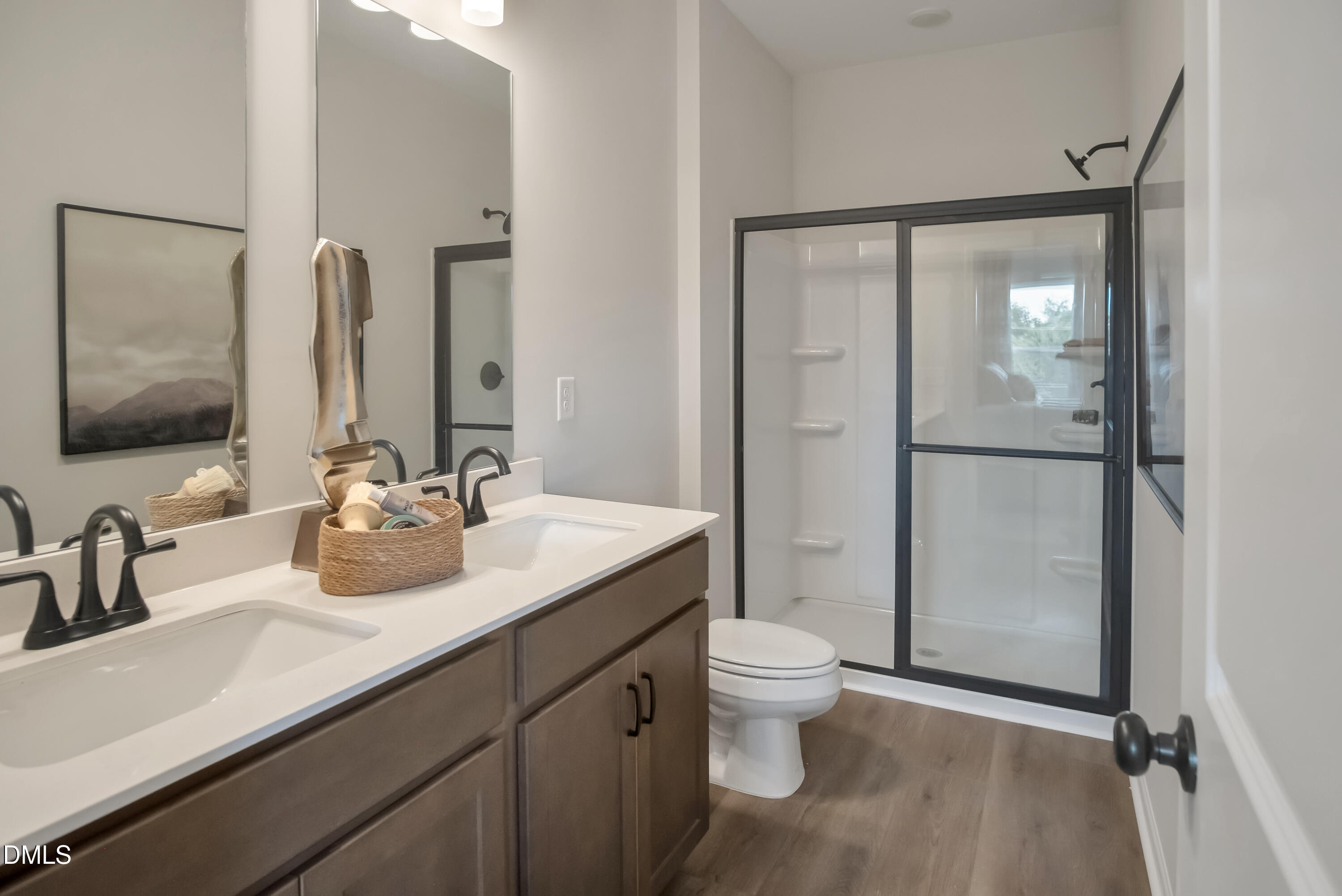 722 Orch Vista Circle Raleigh, NC 27606 - Photo 11 of 30 a bathroom with a double vanity sink toilet mirror and shower