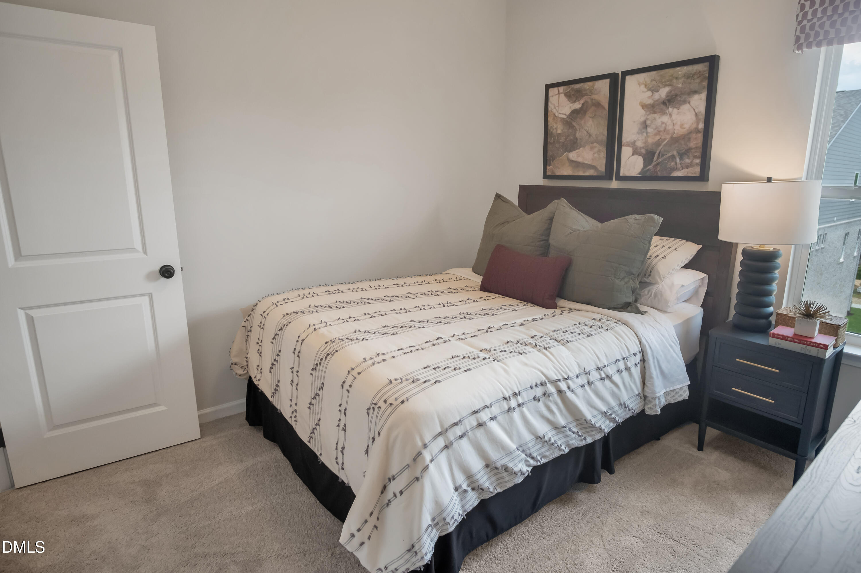 722 Orch Vista Circle Raleigh, NC 27606 - Photo 7 of 30 a bed sitting in a bedroom next to a window