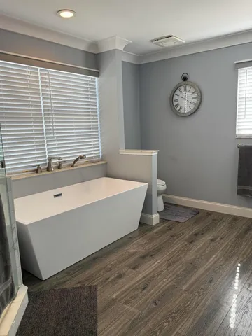 a bathroom with a bathtub and a window