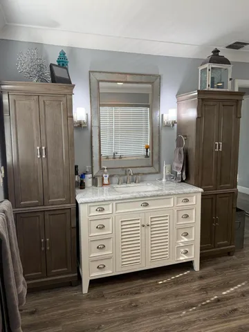 a bathroom with a double vanity sink and mirror