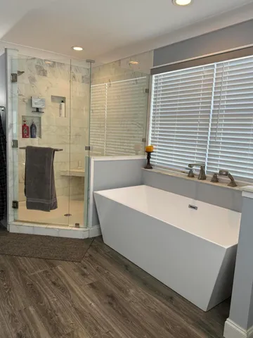 a bathroom with a bathtub and a shower