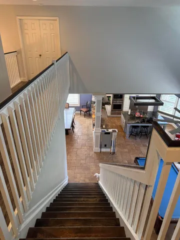 a view of a livingroom with furniture and staircase