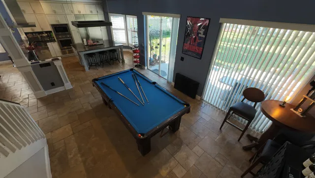 a open kitchen with stainless steel appliances dining table and chairs