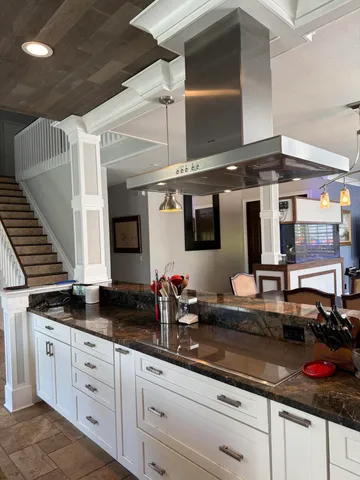 a kitchen with stainless steel appliances granite countertop a sink and cabinets