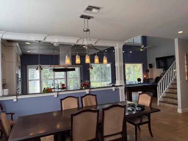 a view of a a dining room with furniture window and wooden floor