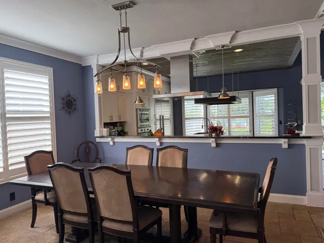 a view of a dining room with furniture and window