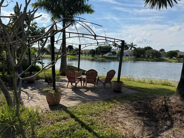 an aerial view of a house with a yard and lake view