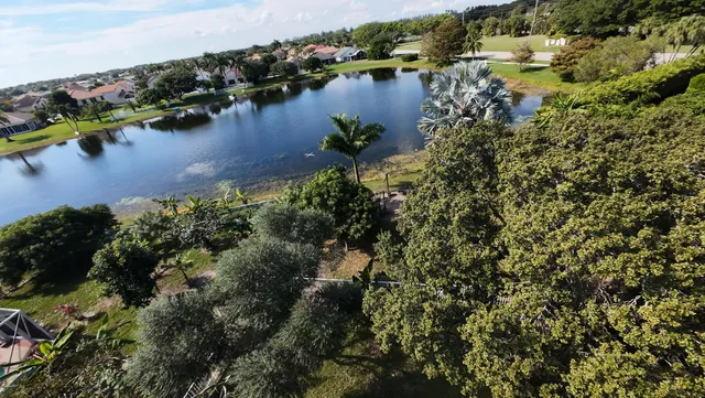 a view of swimming pool with lawn chairs and a yard