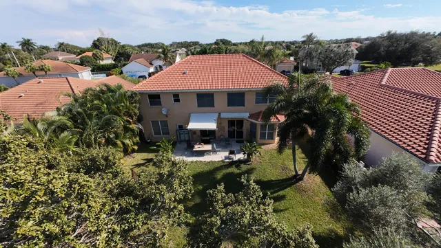 a view of a house with pool and sitting area