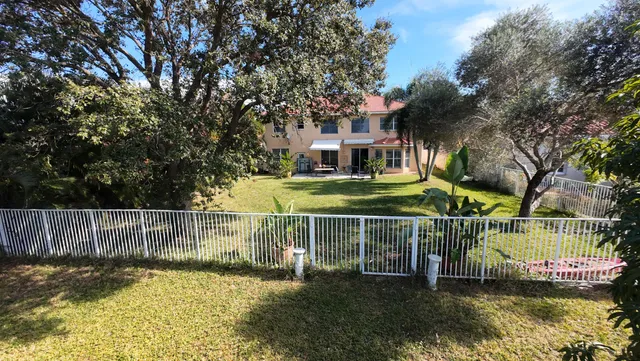 a view of house with a swimming pool