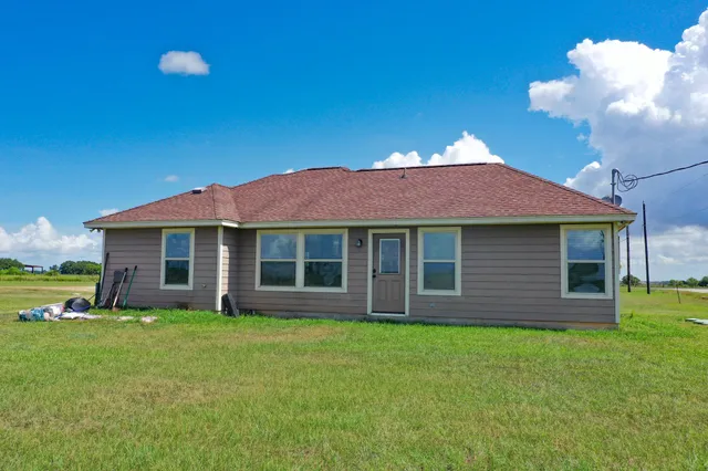 a front view of a house with yard and green space