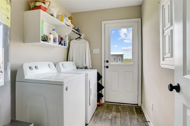 a view of a house with a big yard potted plants and large tree