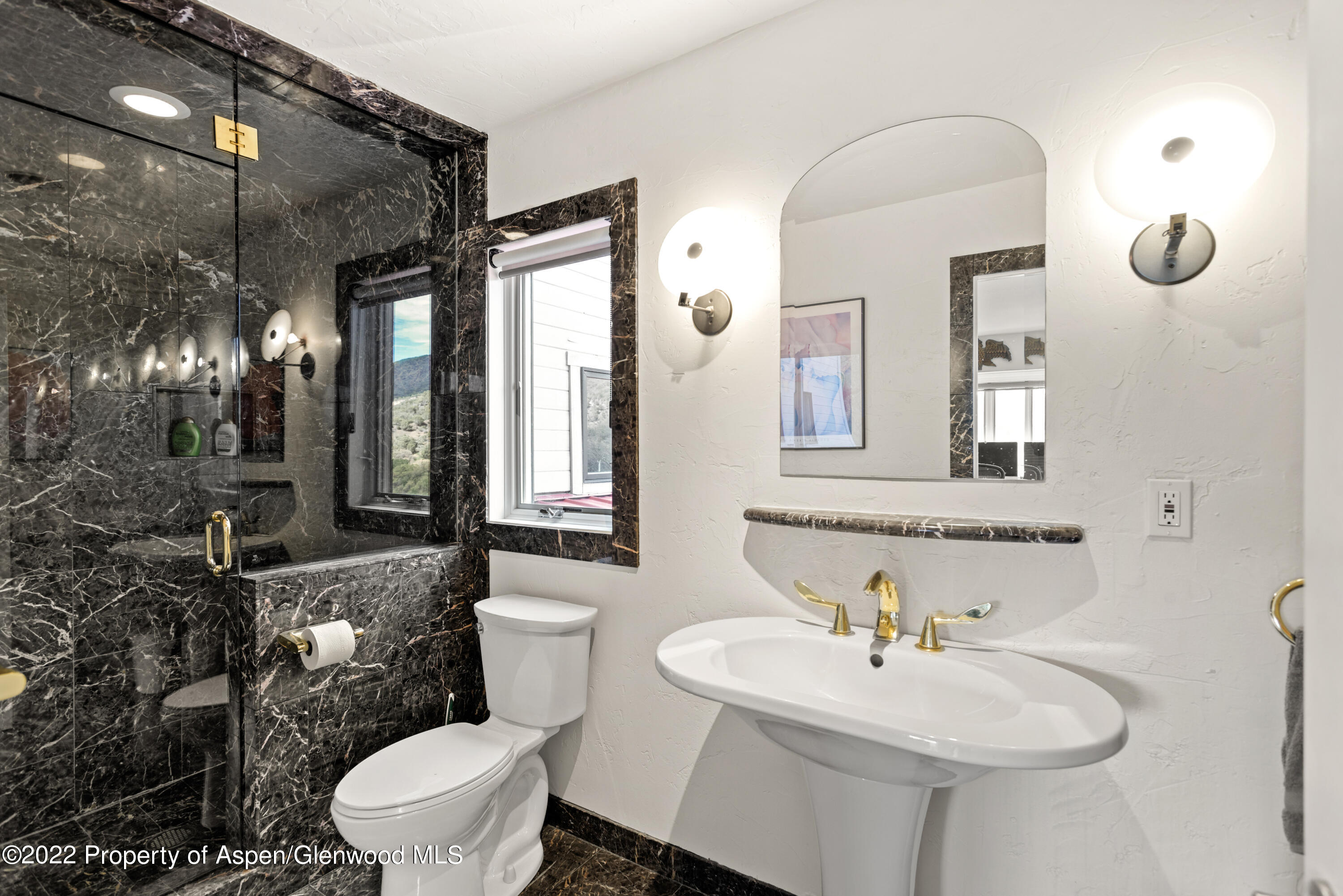 540 Upper Ranch Road Aspen, CO 81611 - Photo 11 of 24 a bathroom with a sink a toilet and mirror