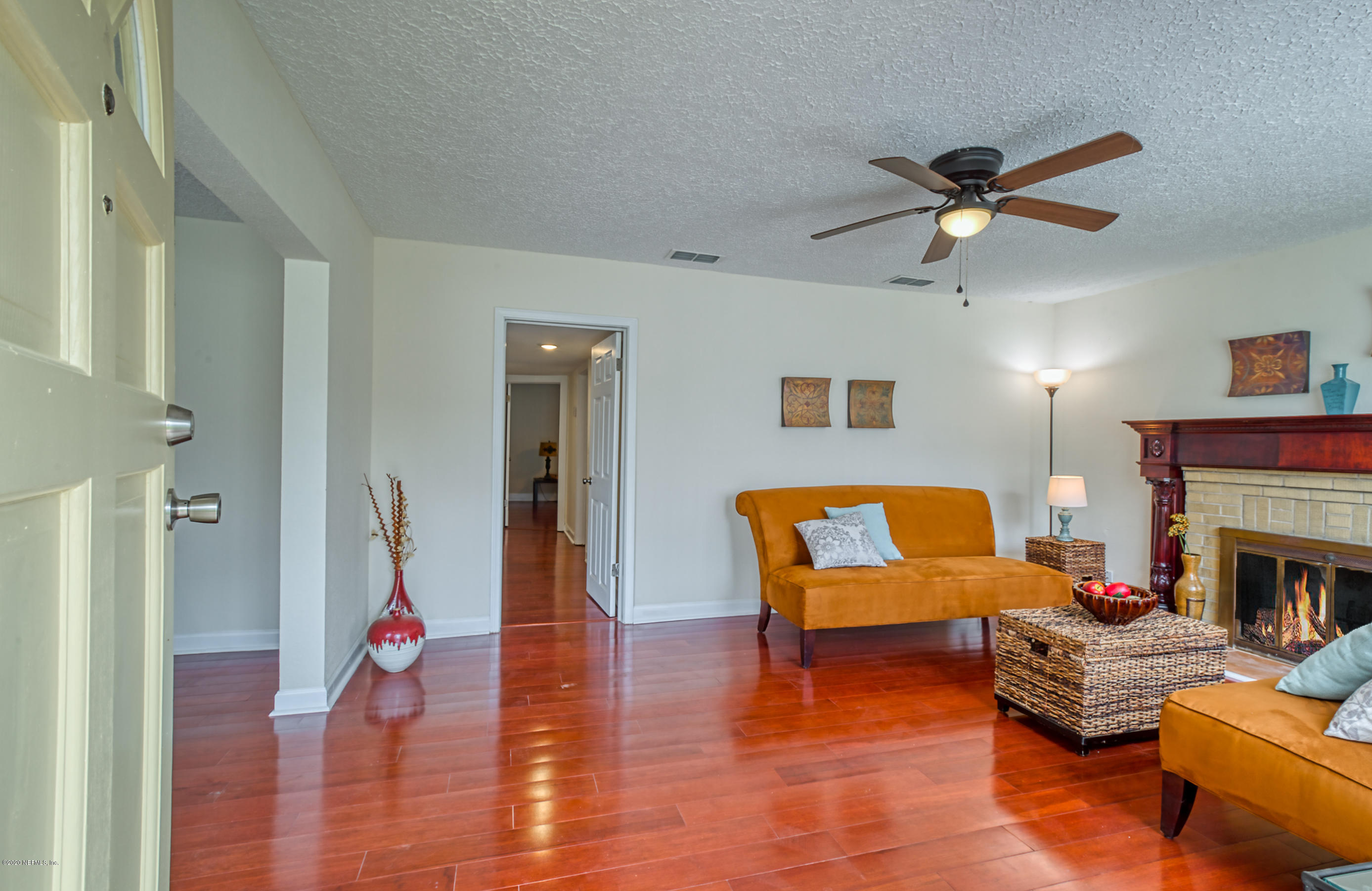 4615 Birkenhead Road Jacksonville, FL 32210 - Photo 2 of 45 a living room with furniture and a fireplace