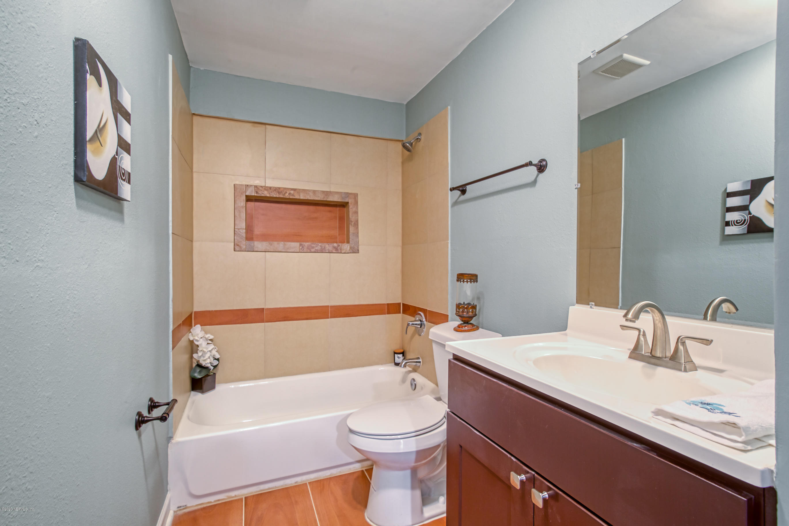 4615 Birkenhead Road Jacksonville, FL 32210 - Photo 21 of 45 a bathroom with a sink a toilet and shower