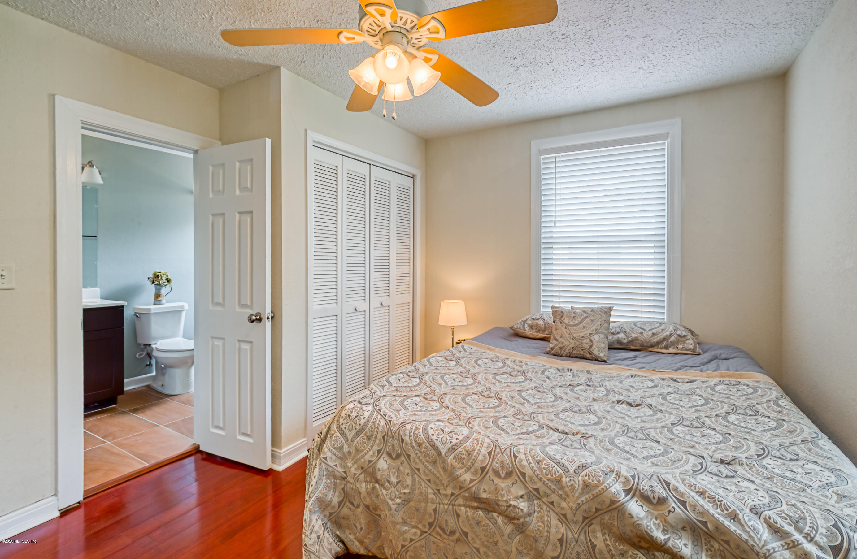 4615 Birkenhead Road Jacksonville, FL 32210 - Photo 28 of 45 a bedroom with a bed and wooden floor