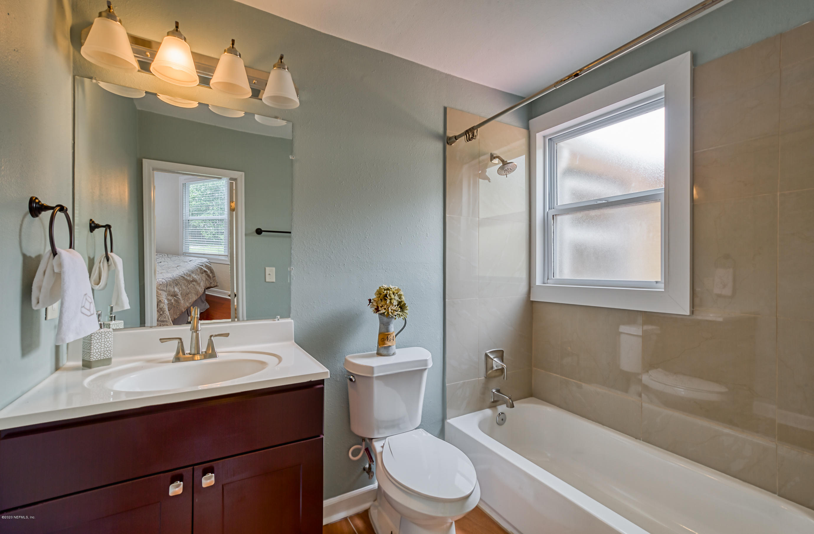 4615 Birkenhead Road Jacksonville, FL 32210 - Photo 29 of 45 a bathroom with a sink mirror vanity and toilet