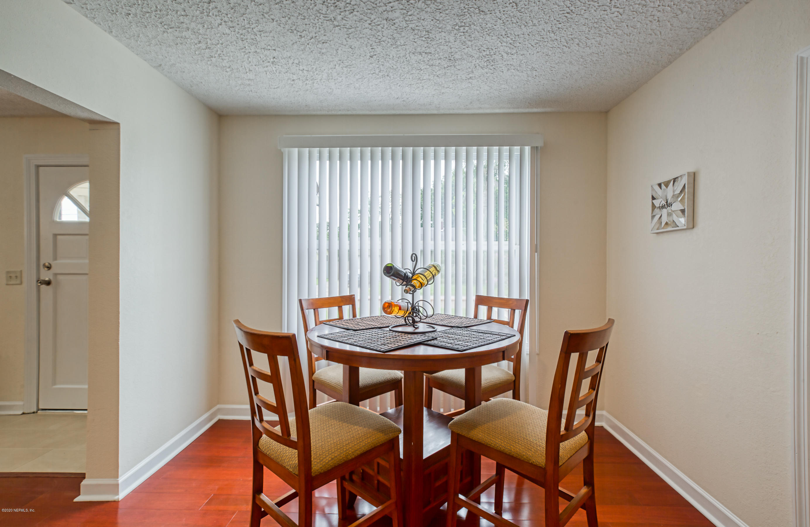 4615 Birkenhead Road Jacksonville, FL 32210 - Photo 9 of 45 a view of a dining room with furniture and wooden floor