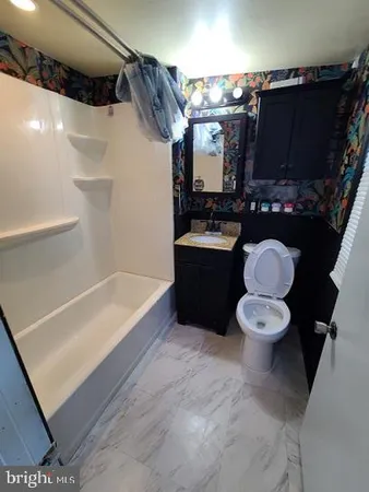 a bathroom with a bathtub and a toilet