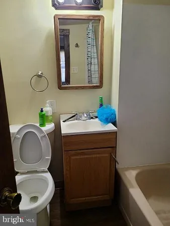 a bathroom with a toilet a sink and mirror