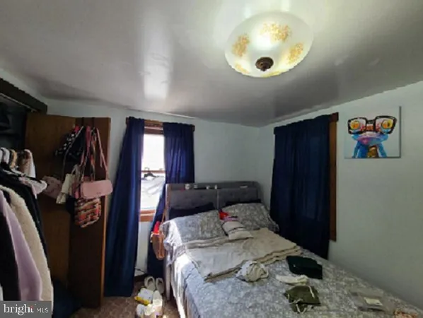 a bedroom with a bed and a large mirror