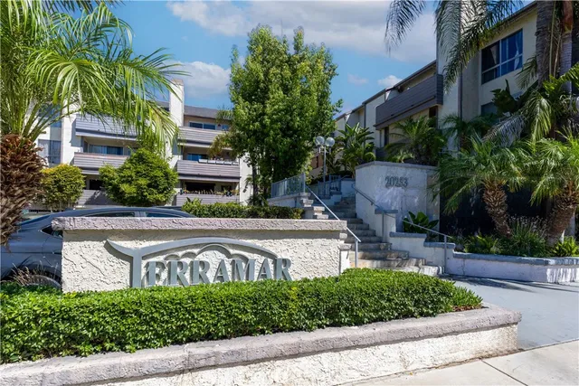 a view of a house with a garden and plants