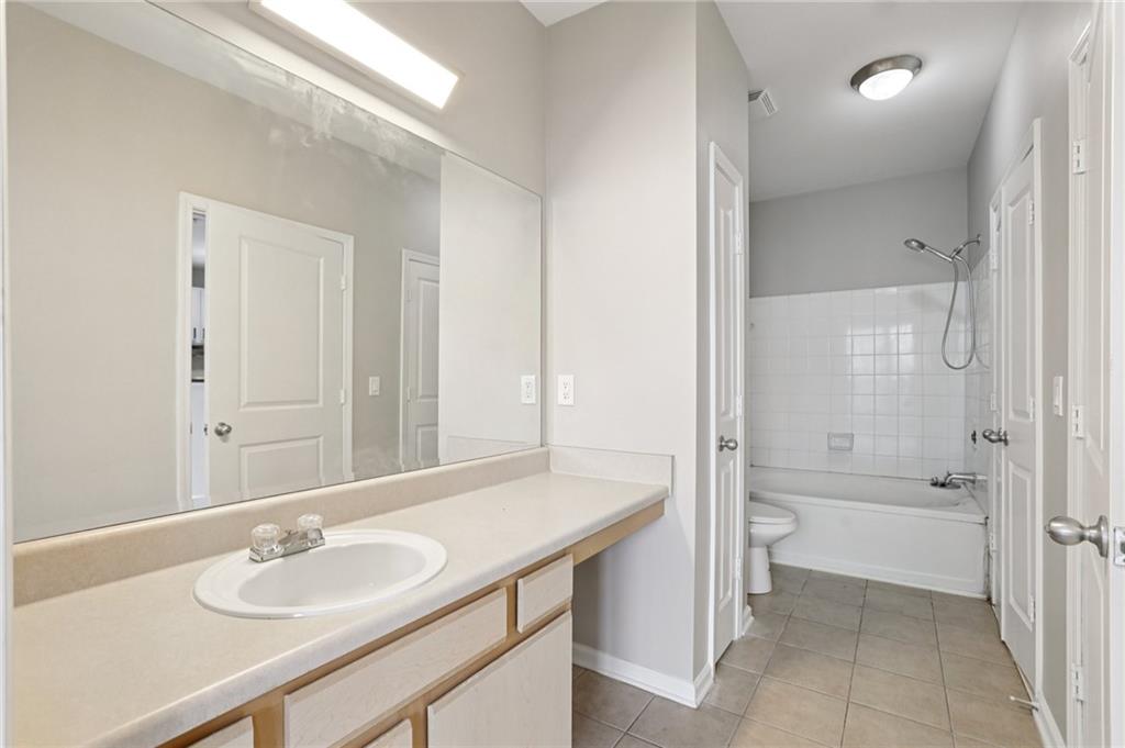821 Ralph McGill Boulevard Northeast, Unit 3404 Atlanta, GA 30306 - Photo 12 of 18 a bathroom with a sink and a mirror