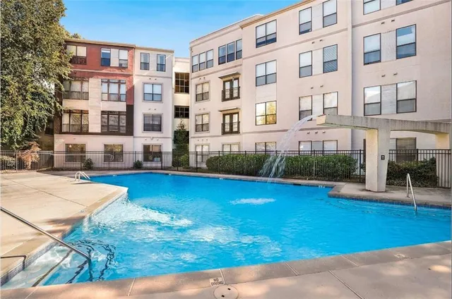 a swimming pool view with a outdoor seating