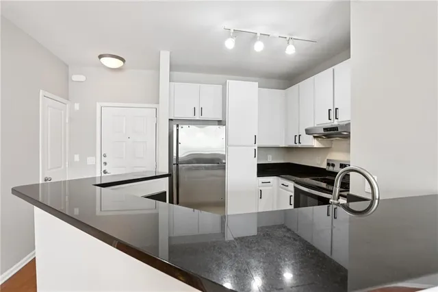 a kitchen with kitchen island a sink appliances and cabinets