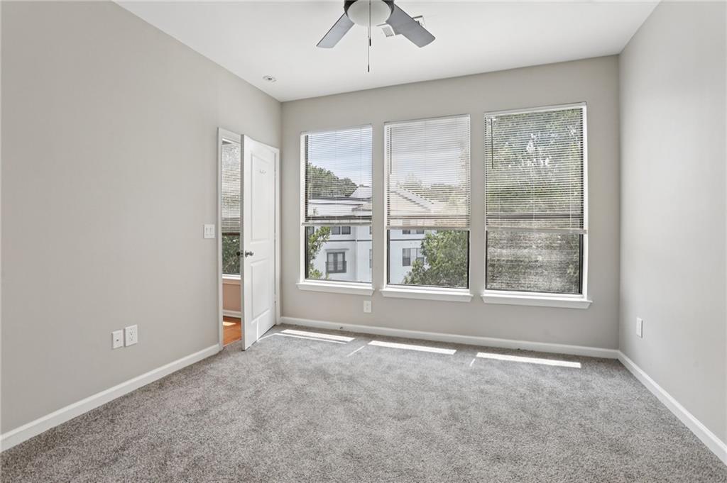 821 Ralph McGill Boulevard Northeast, Unit 3404 Atlanta, GA 30306 - Photo 8 of 18 an empty room with a empty space and windows