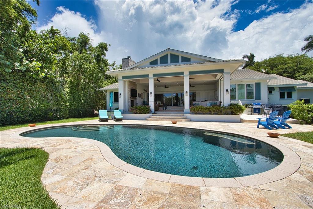 a view of a house with swimming pool and a porch with furniture