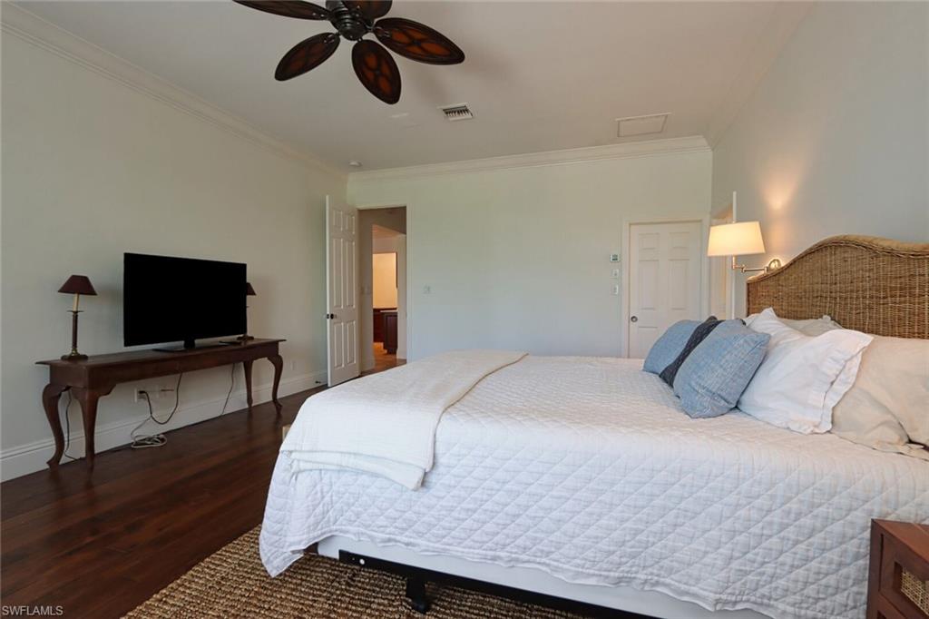 2201 Beacon Lane Naples, FL 34103 - Photo 16 of 41 a bedroom with a bed and a flat screen tv