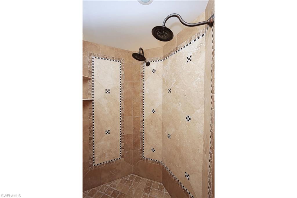 2201 Beacon Lane Naples, FL 34103 - Photo 18 of 41 a bathroom with a shower and a mirror