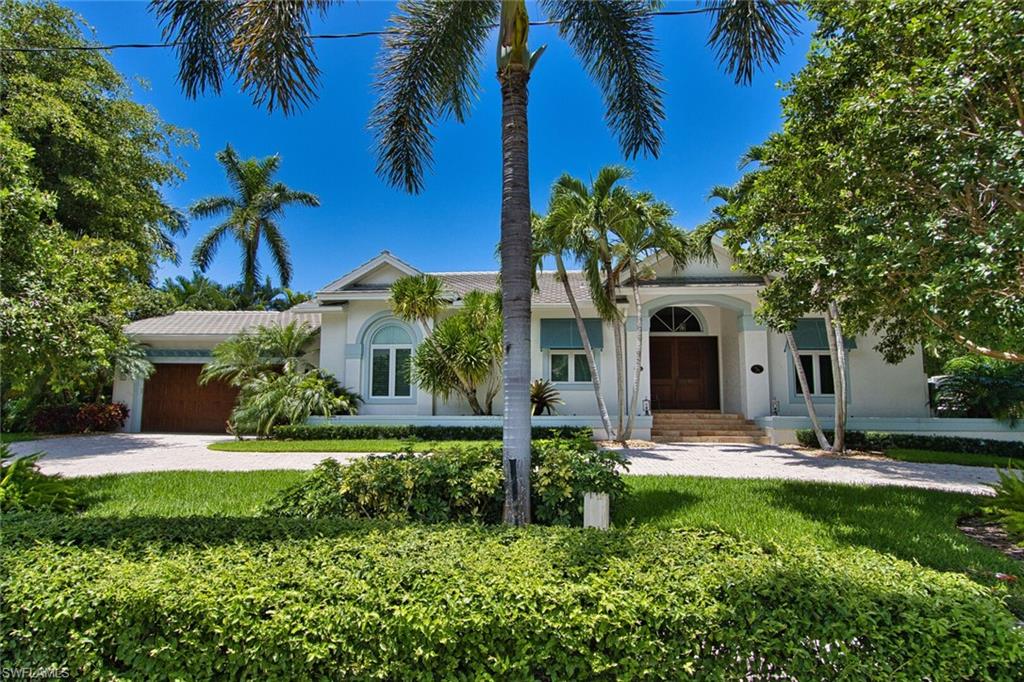 2201 Beacon Lane Naples, FL 34103 - Photo 2 of 41 a front view of a house with a yard and garage