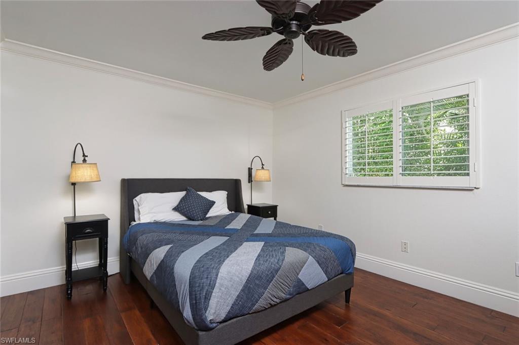 2201 Beacon Lane Naples, FL 34103 - Photo 21 of 41 a bedroom with a bed and wooden floor