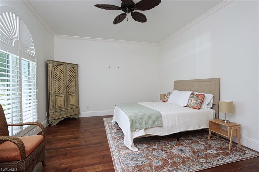 2201 Beacon Lane Naples, FL 34103 - Photo 24 of 41 a bedroom with a bed and wooden floor