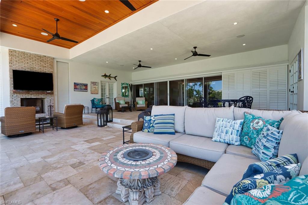 2201 Beacon Lane Naples, FL 34103 - Photo 28 of 41 a living room with furniture and a flat screen tv