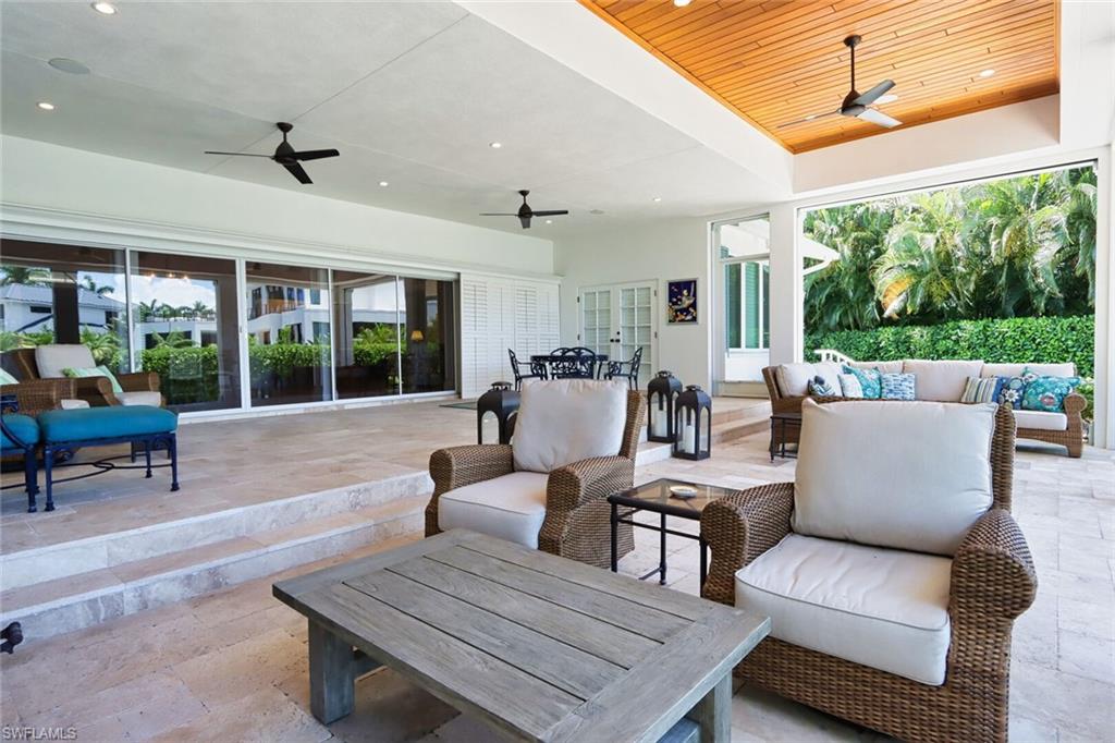 2201 Beacon Lane Naples, FL 34103 - Photo 30 of 41 a outdoor living space with furniture potted plant and a large window
